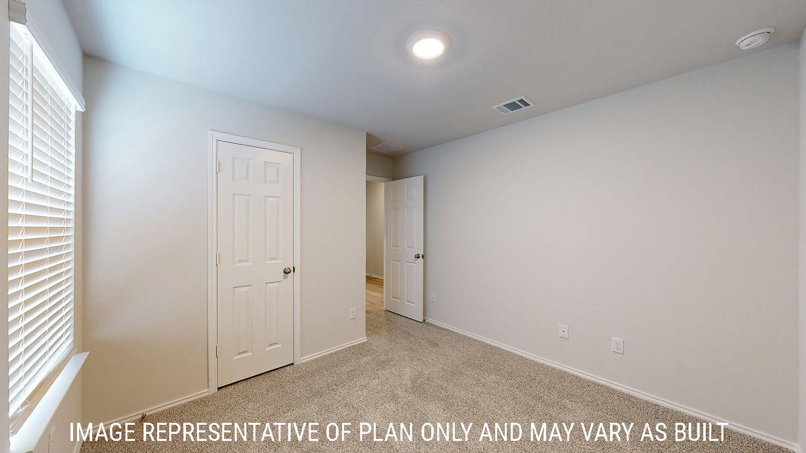 Harris secondary bedroom with carpeted flooring and window for lighting.