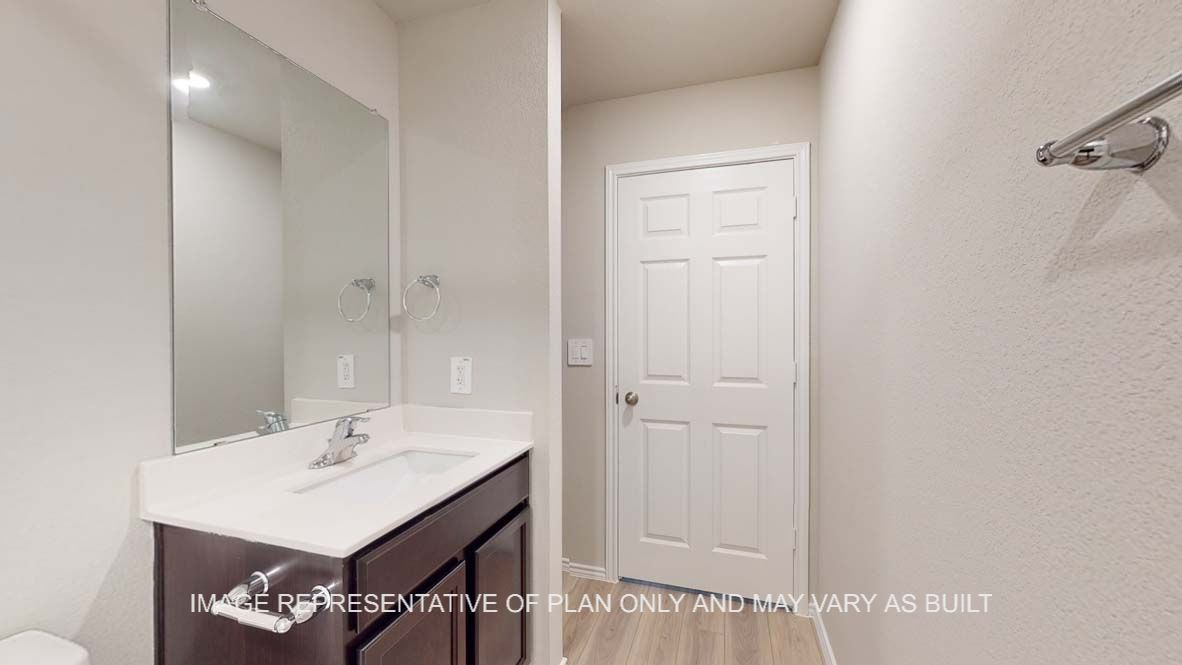 Bellvue secondary bath with dark cabinets and white countertops.