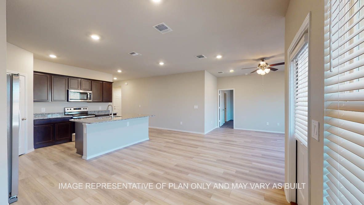 Texas Cali open concept dining room and living room with vinyl plank flooring throughout.