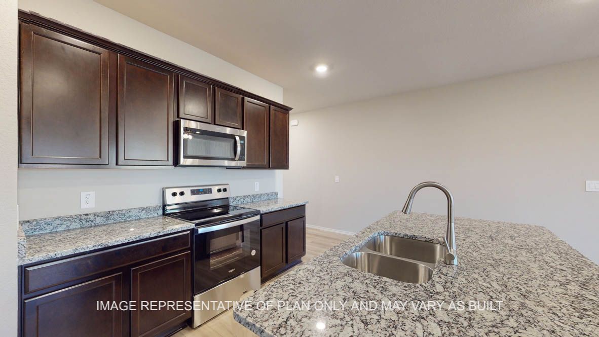 Texas Cali kitchen with dark cabinets and granite countertops.