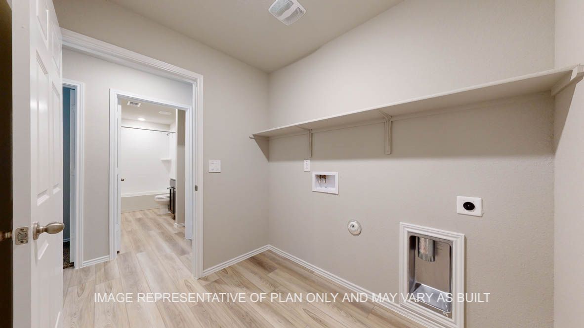 Seabrook utility room with vinyl plank flooring and storage shelf.