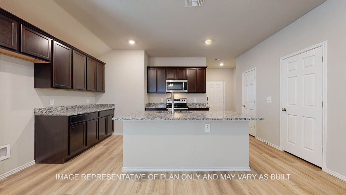 Seabrook kitchen with dark cabinets and granite countertops.