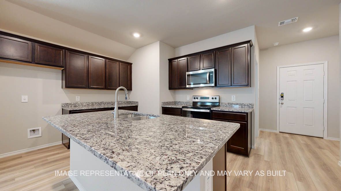 Seabrook kitchen with dark cabinets and granite countertops.