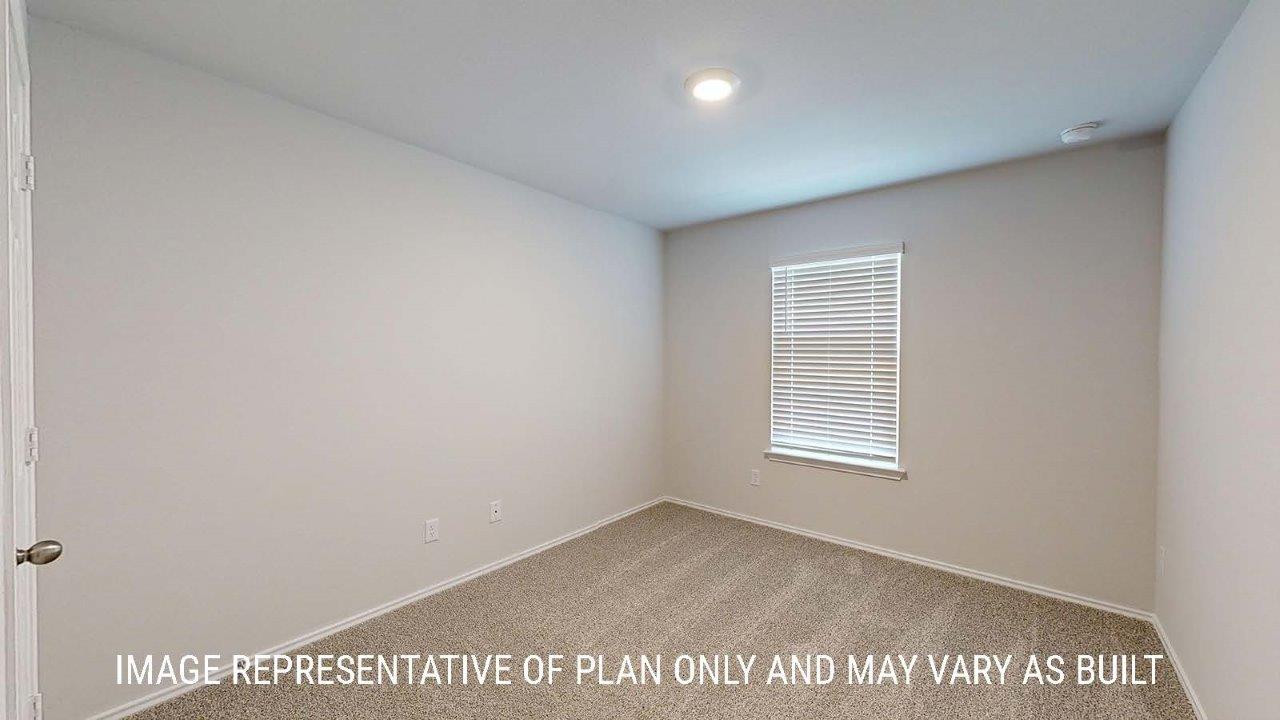 Emma secondary bedroom with carpeted flooring and window for lighting.