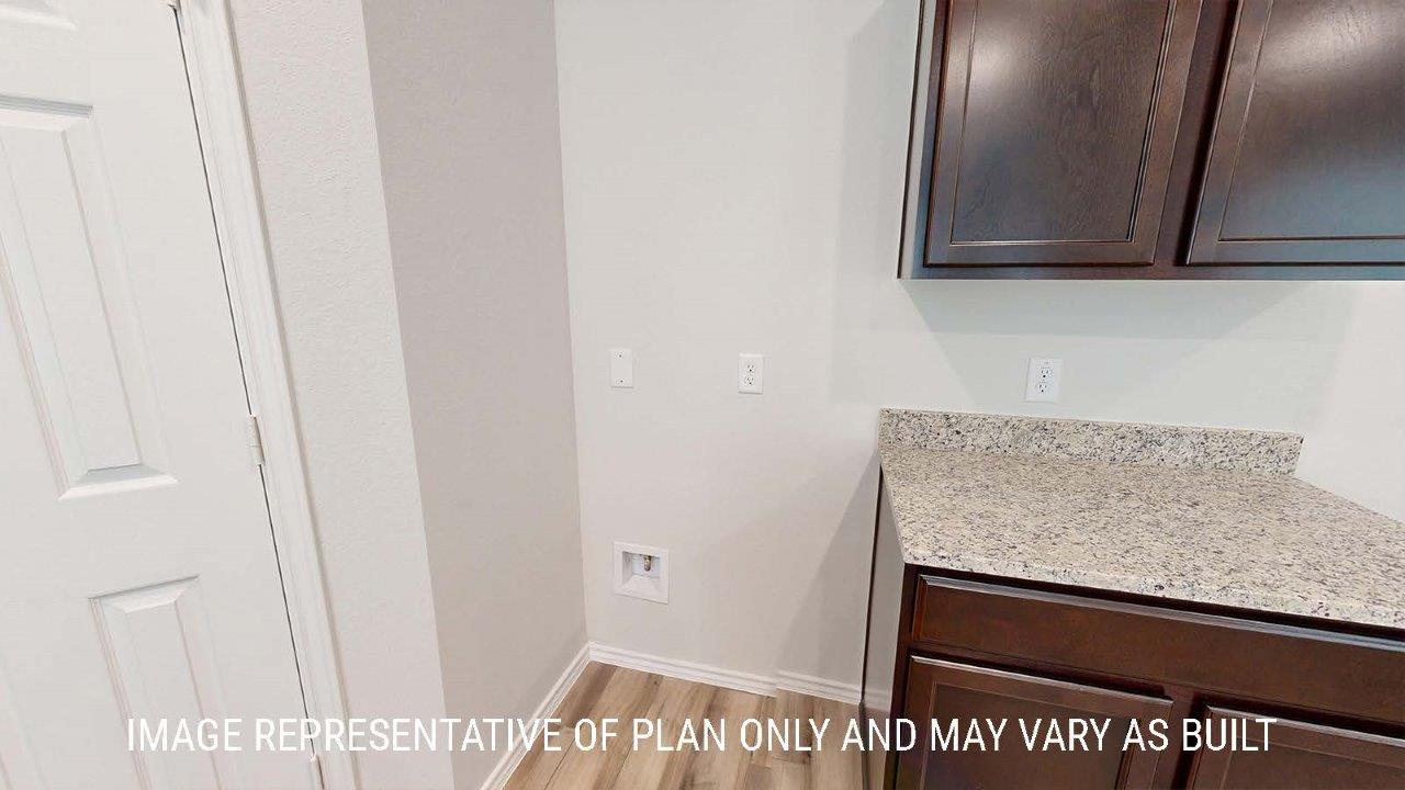 Emma kitchen with dark cabinets and granite countertops.