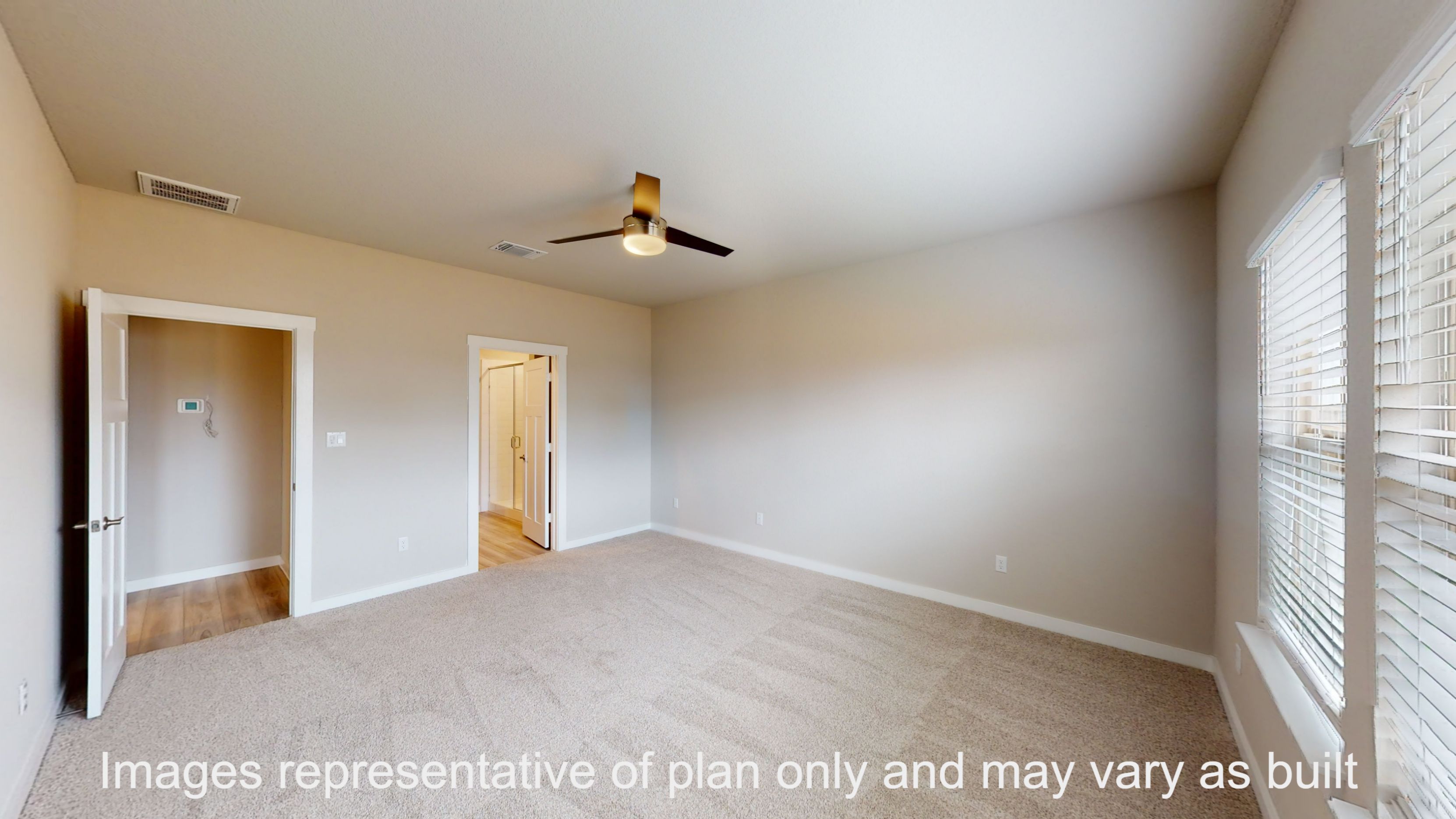 Florence primary bedroom with carpet flooring and view of primary bathroom.