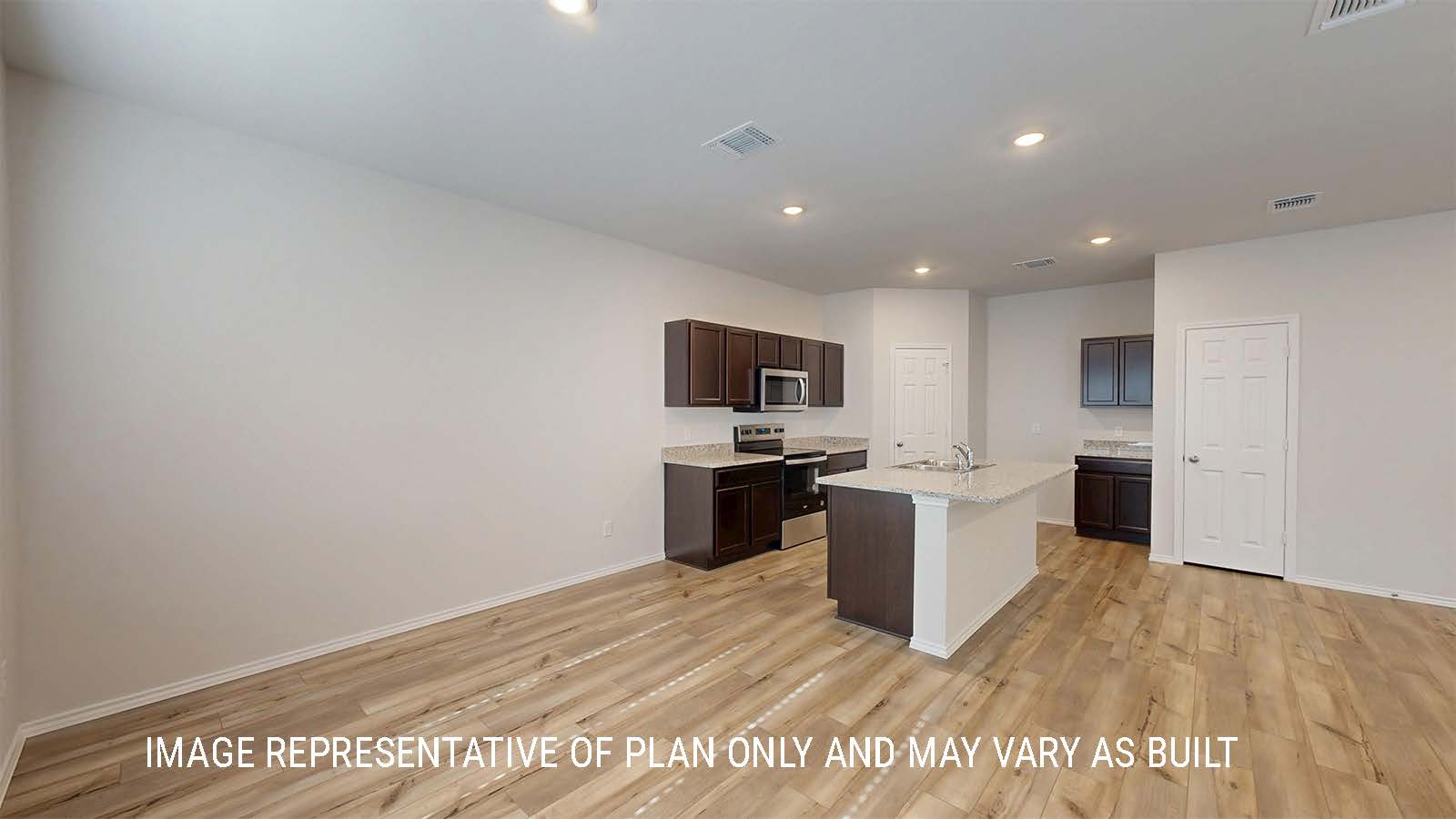 Grace dining room with view of kitchen with dark cabinets and granite countertops.