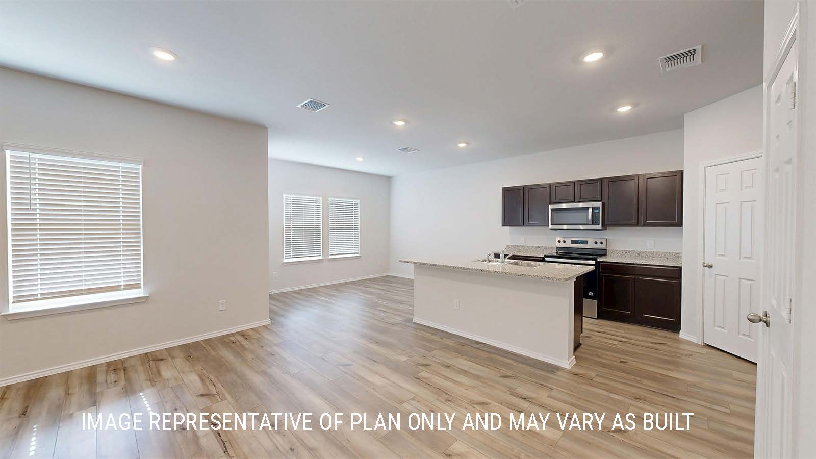 Grace living room with view of open concept kitchen and dining room.
