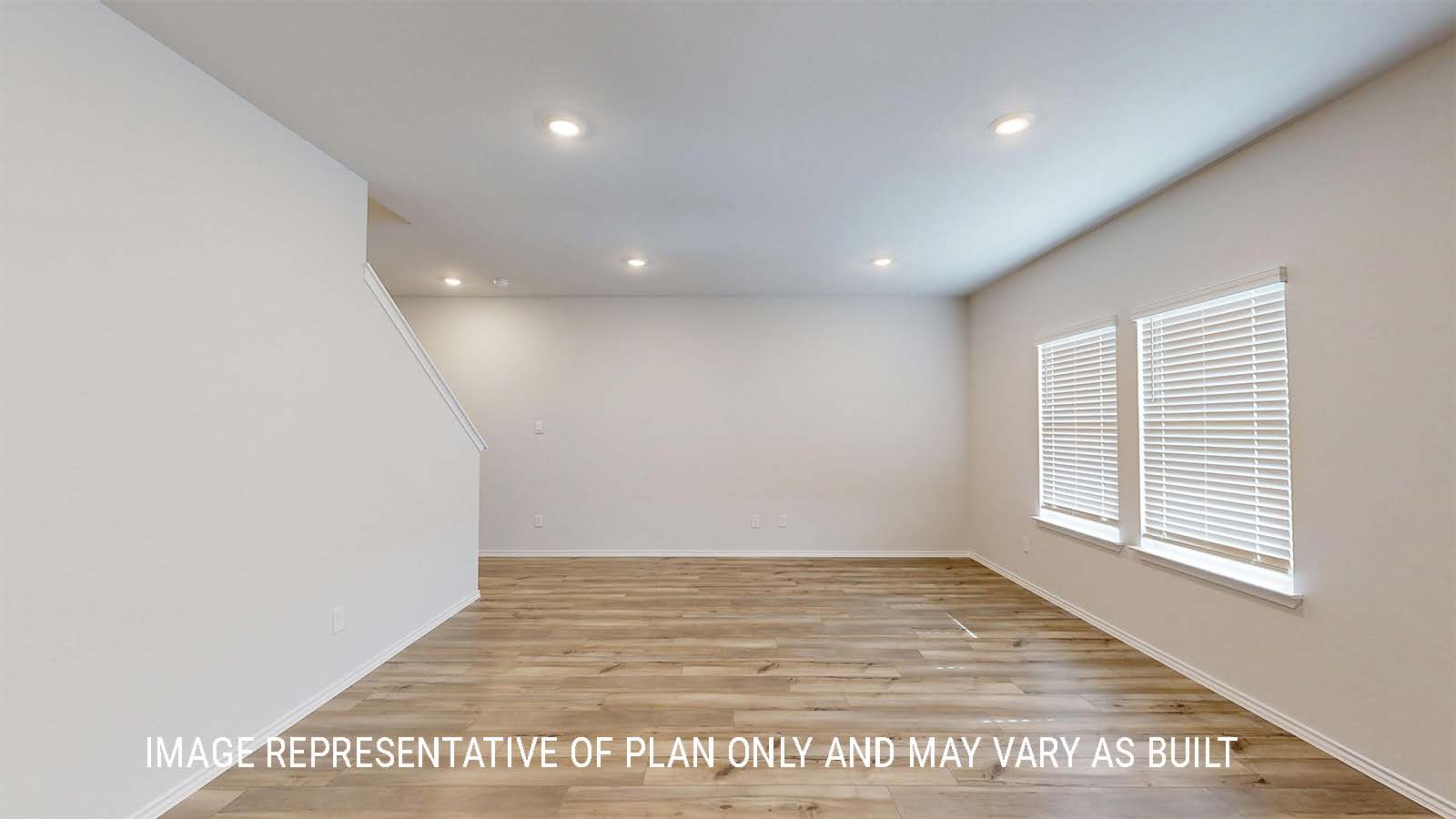 Grace living room with vinyl plank flooring and windows for lighting.