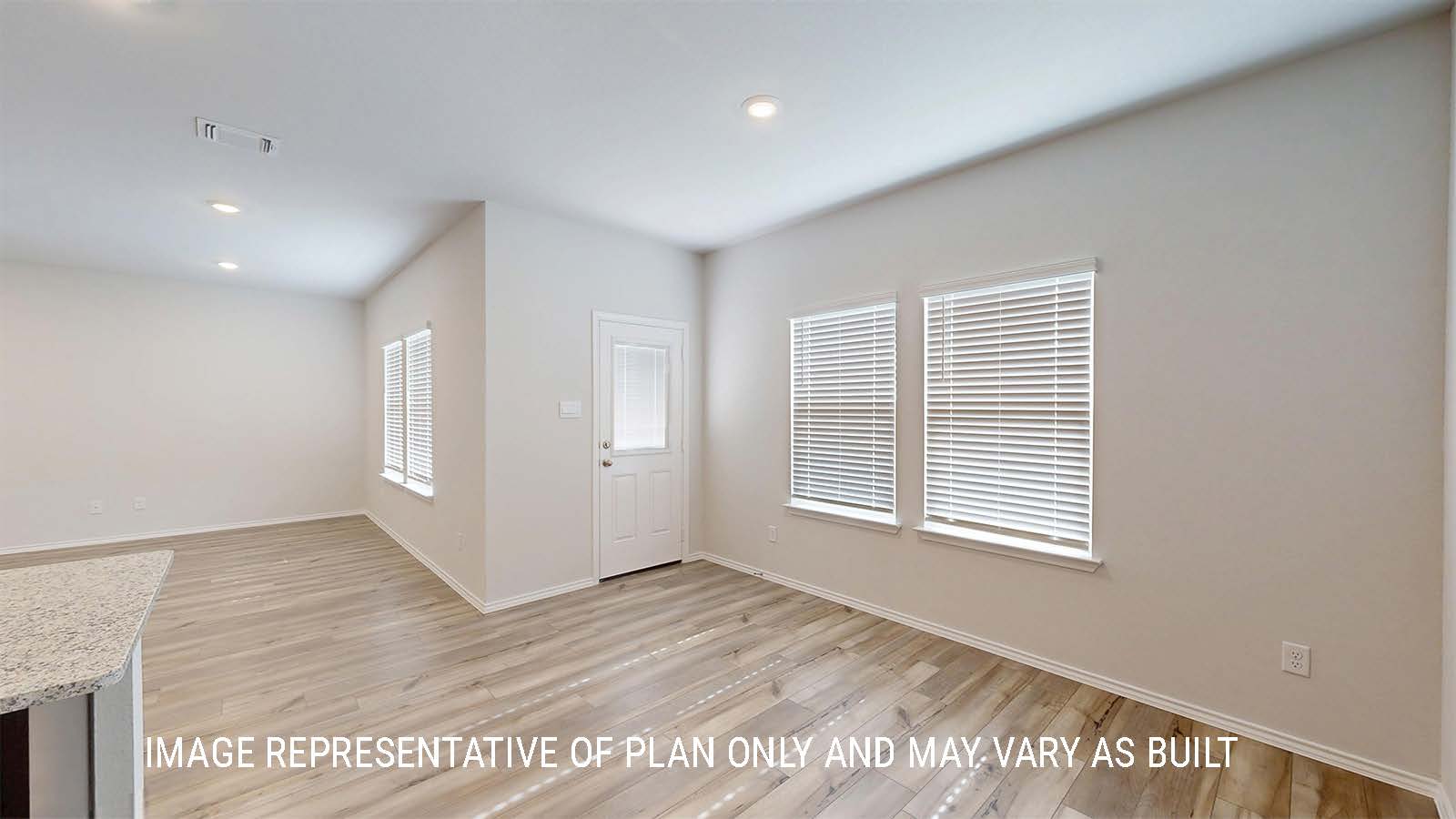 Grace dining room with view of living room and back door.