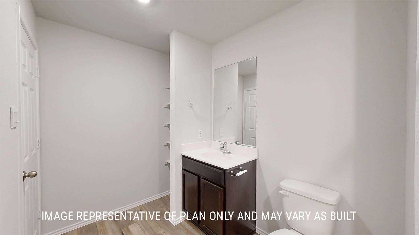 Grace half bathroom with single vanity and shelving for storage.