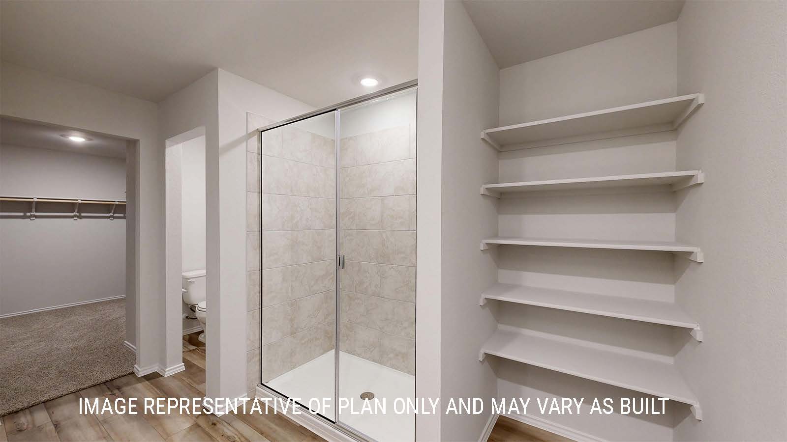 Grace primary bathroom with walk-in shower and view of the primary closet.