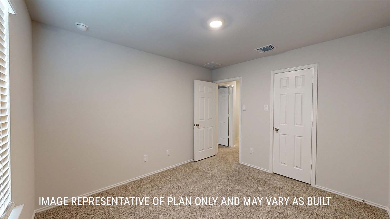 Grace secondary bedroom with carpeted flooring and closet door.