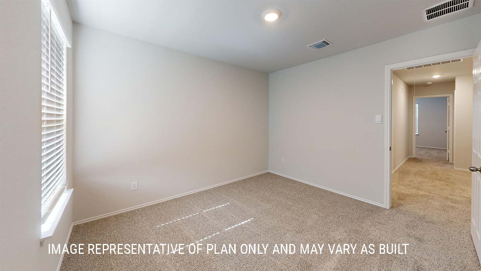 Grace secondary bedroom with carpeted flooring and closet door.