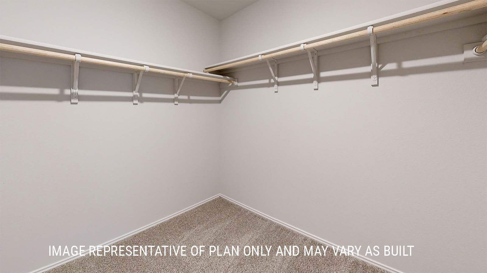 Grace primary closet with carpeted flooring and shelving for storage.