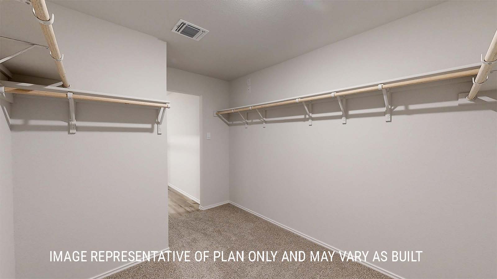 Grace primary closet with carpeted flooring and shelving for storage.