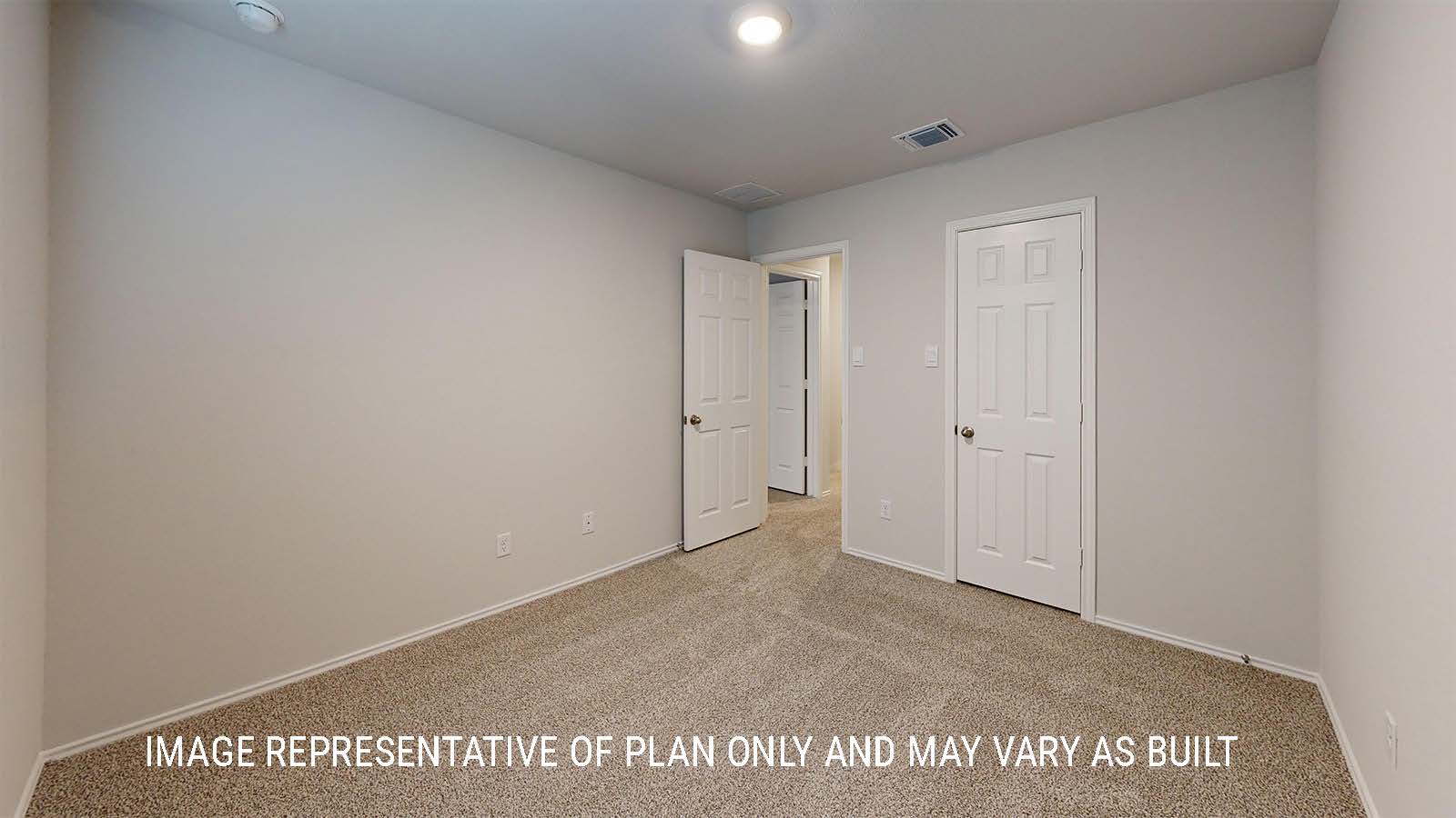 Grace secondary bedroom with carpeted flooring and closet door.