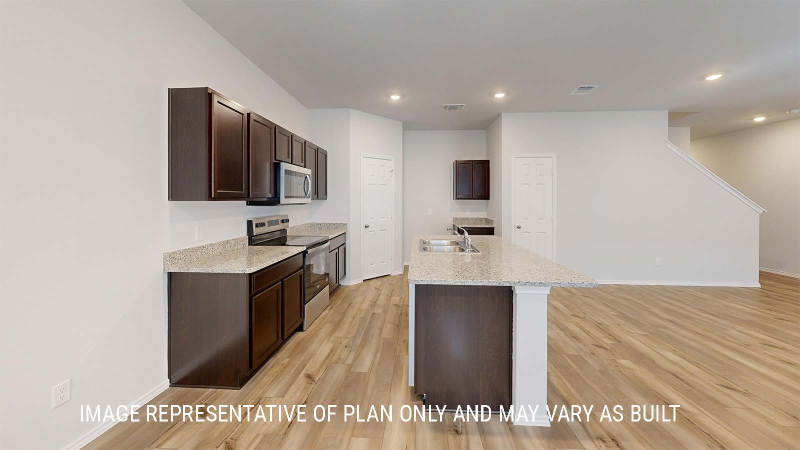 Grace kitchen with dark cabinets and granite countertops.