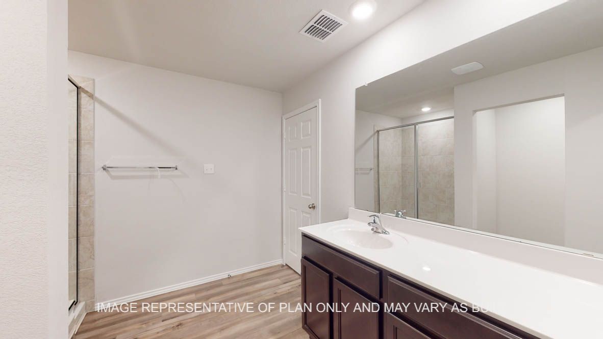 Abbot primary bathroom with vanity sink and view of primary closet.