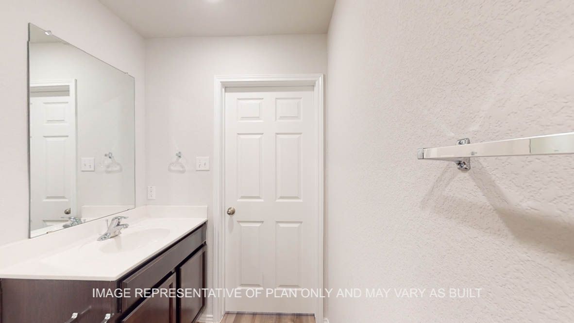 Abbot secondary bathroom with vanity sink and mirror.