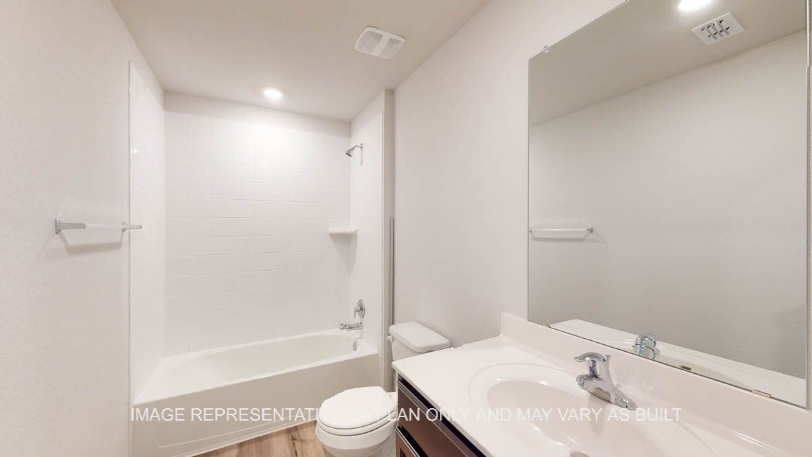 Abbot secondary bathroom with vanity sink and shower and bath tub combo.