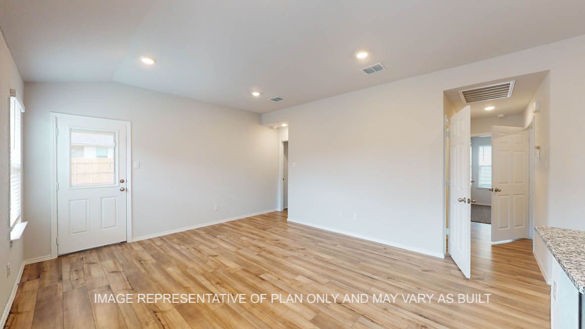 Abbot living room with vinyl plank flooring and view of back door.