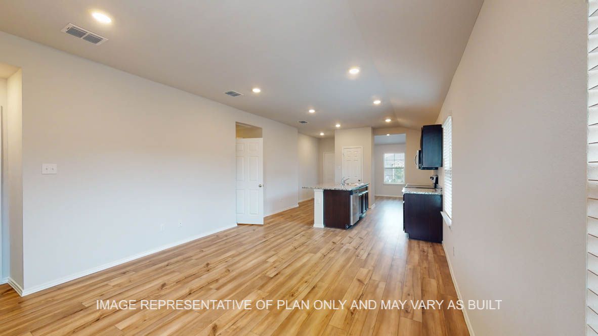 Abbot dining room with vinyl plank flooring and view of kitchen.