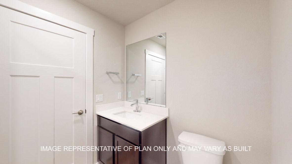Baxtor secondary bath with single vanity and tub and shower combination.