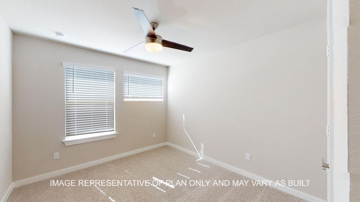 Baxtor secondary bedroom with carpet flooring.