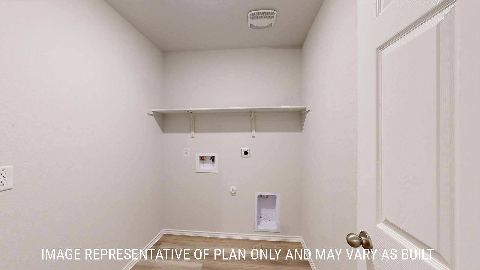 Caden utility room with washer and dryer connections and shelving for storage.