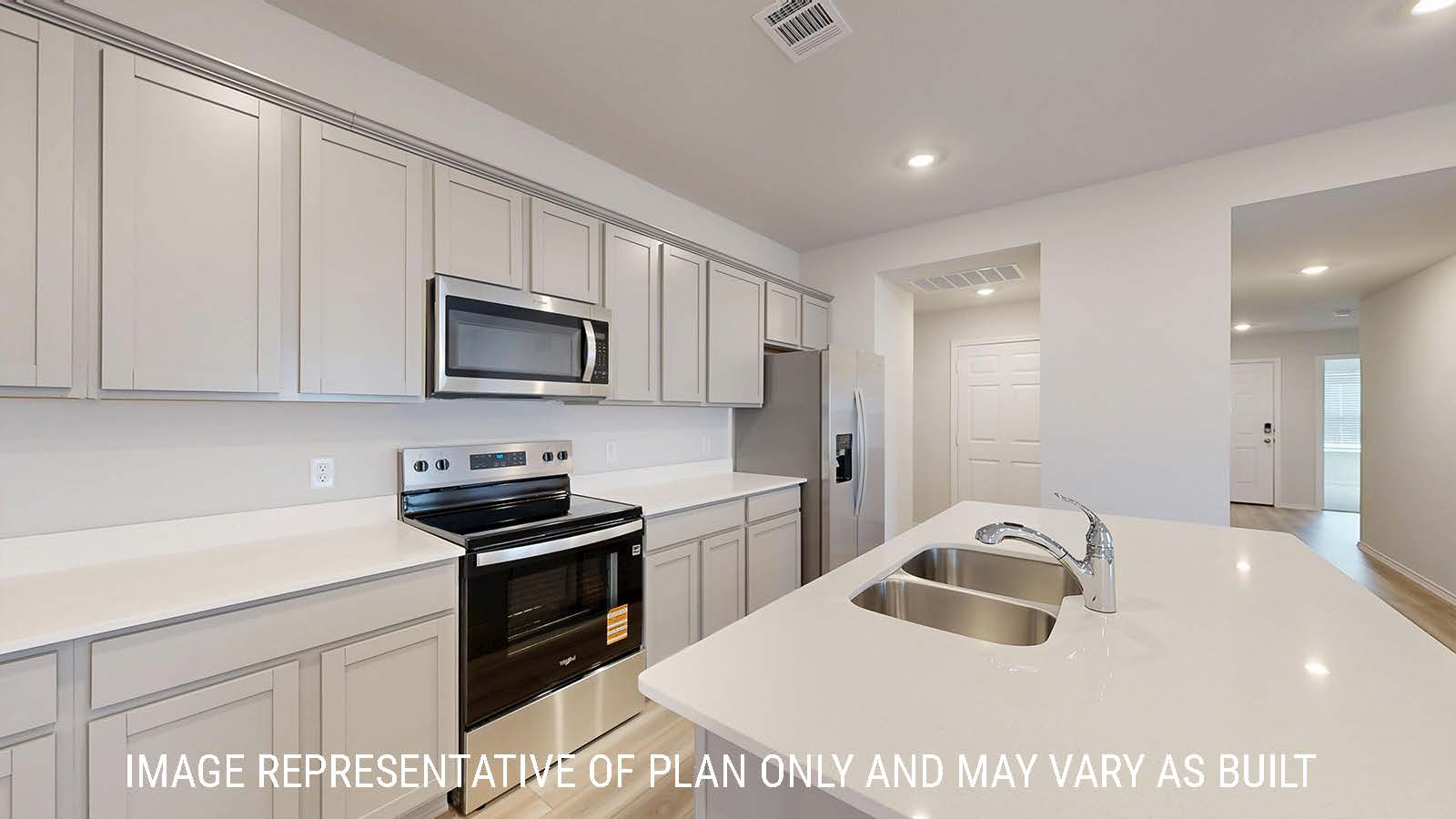Caden kitchen light cabinets and light countertops with view of front hallway.