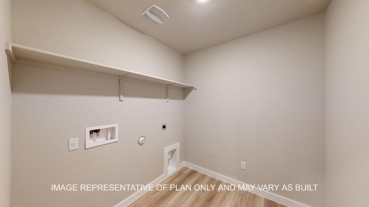 Easton utility room with vinyl plank flooring and storage shelf.