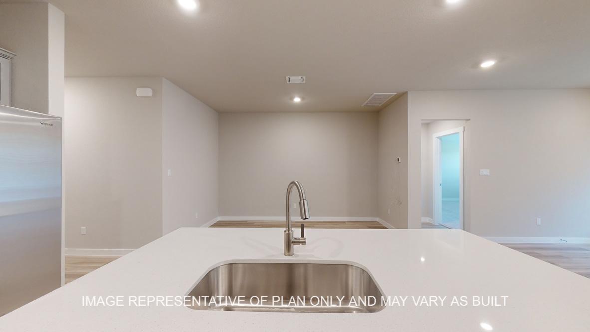 Easton kitchen with quartz kitchen island, gray cabinets and vinyl plank flooring.