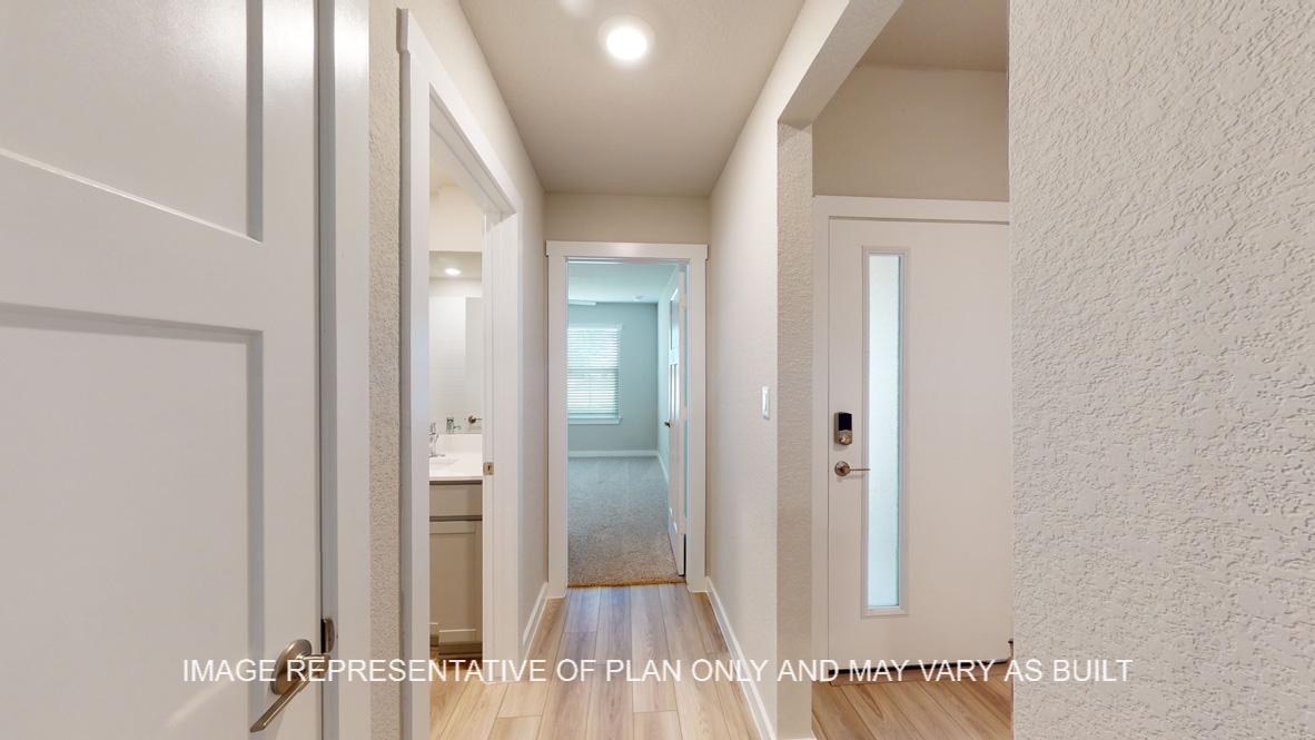 Easton entry with view to hallway with half bath and secondary bedrooms.