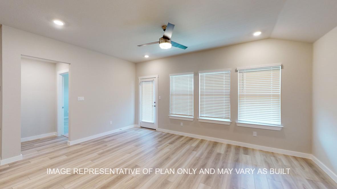 Easton living room with vinyl plank flooring and windows to the backyard.