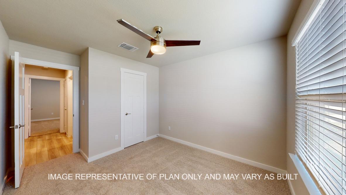 Easton secondary bedroom with carpet flooring and modern ceiling fan.