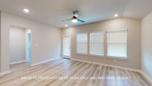 Easton living room with vinyl plank flooring and windows to the backyard.