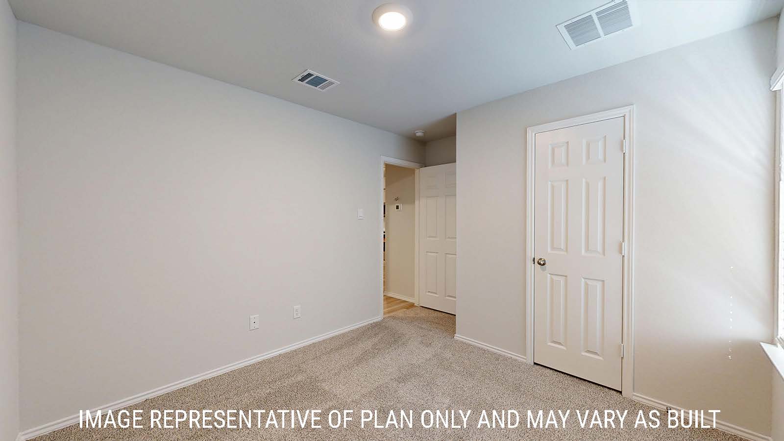 Gaven secondary bedroom with carpeted flooring and view of hallway.