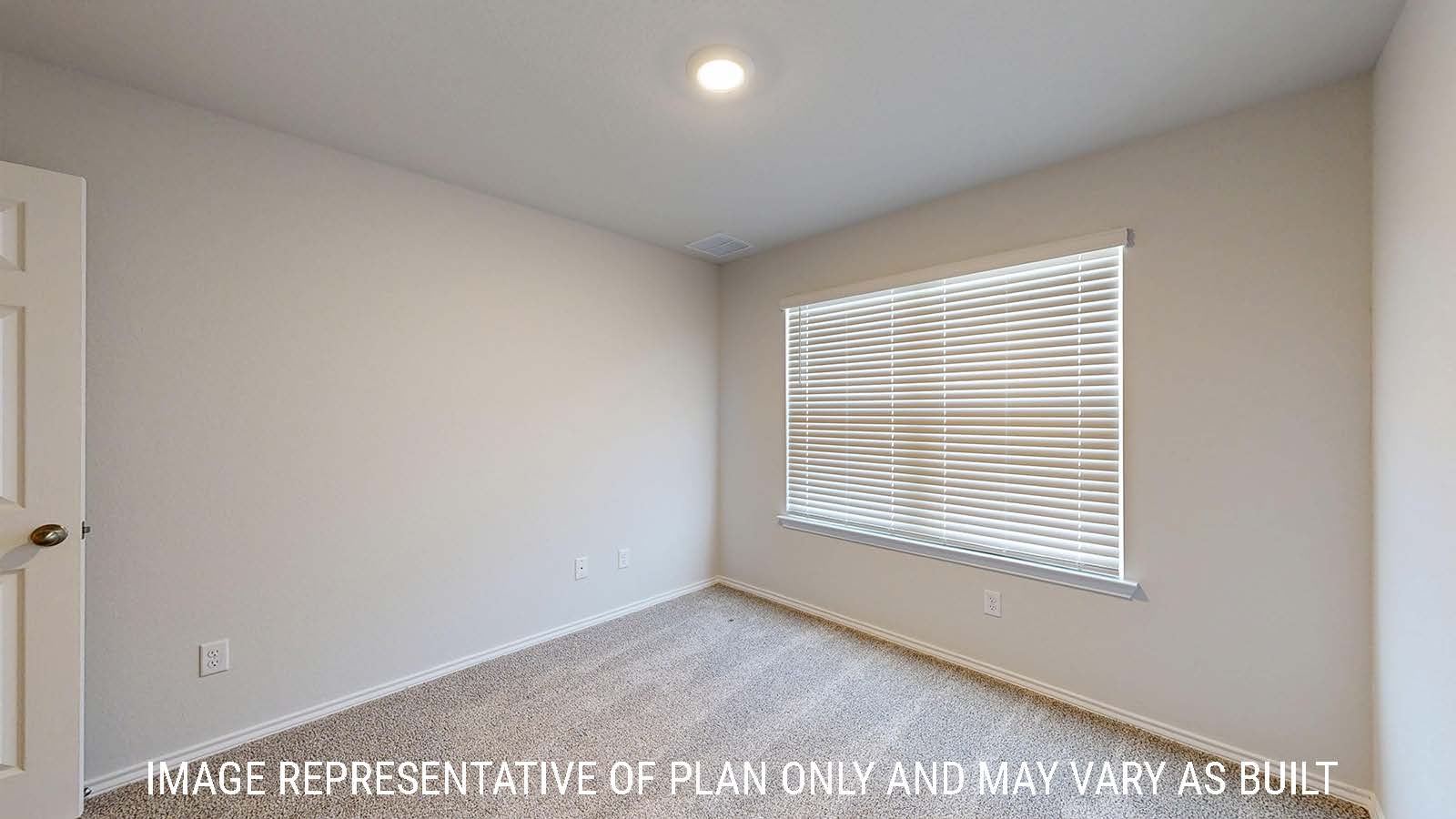 Gaven secondary bedroom with carpeted flooring and window for natural lighting.