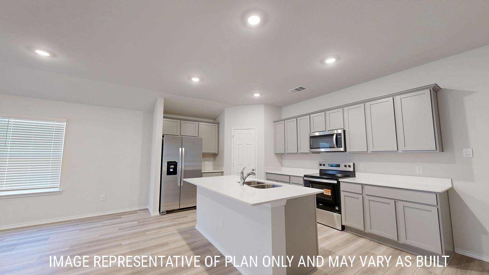 Gaven kitchen with kitchen island and light cabinets with white countertops.
