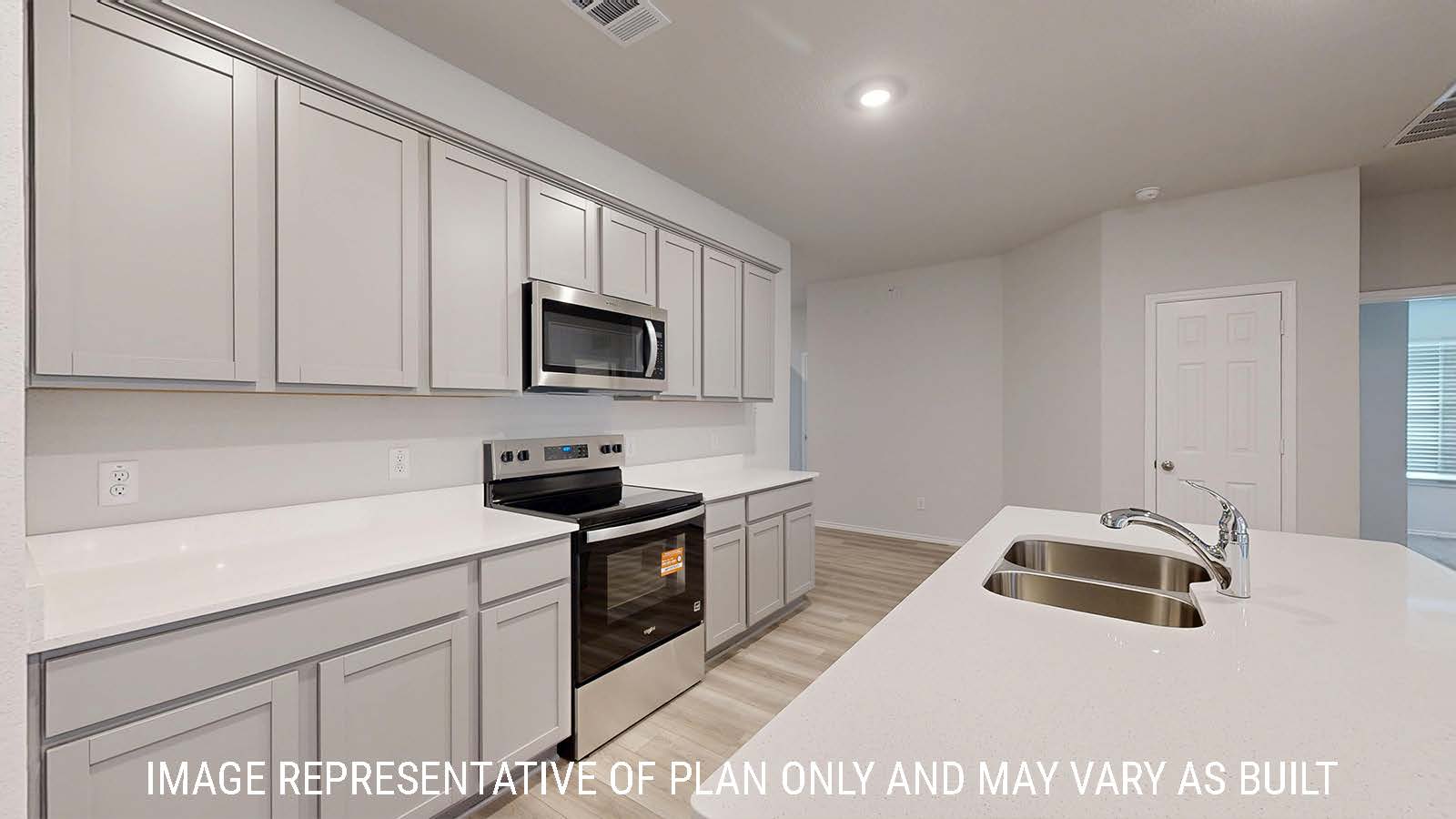 Gaven kitchen with kitchen island and light cabinets with white countertops.
