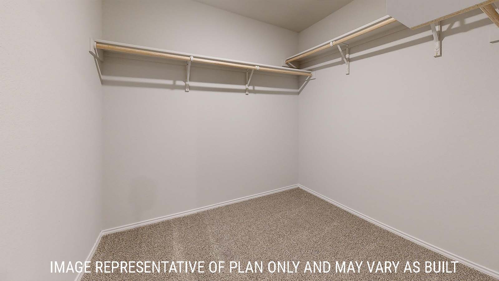 Gaven primary bedroom closet with carpeted flooring and shelving for storage.