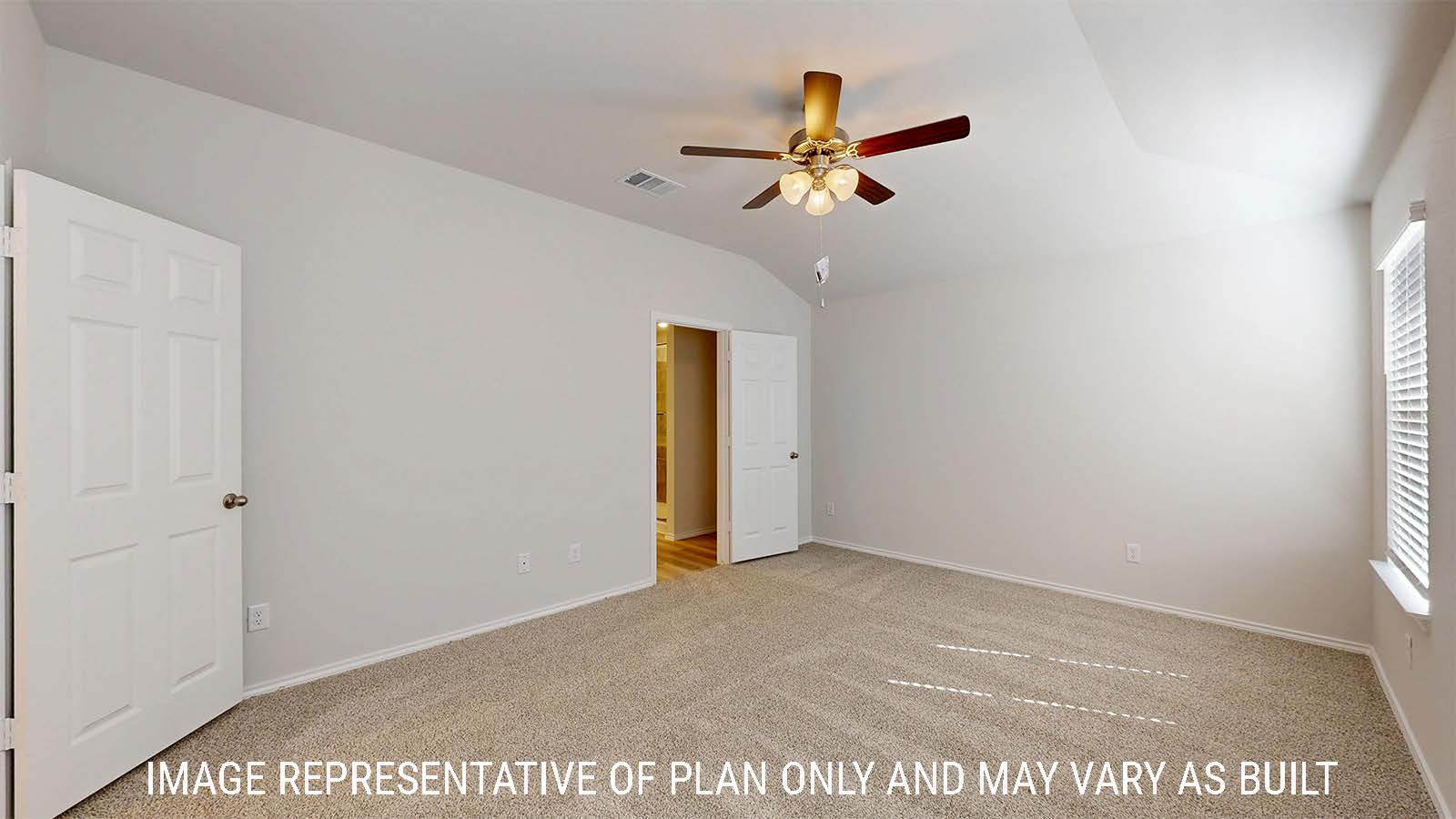 Gaven primary bedroom with carpeted flooring and view of primary bathroom.