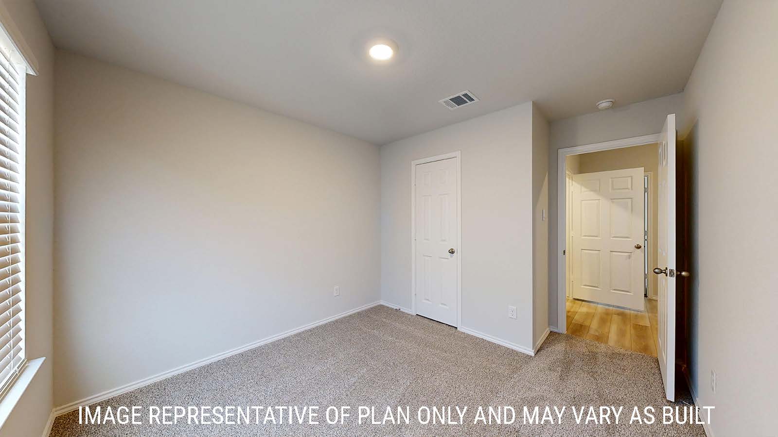 Gaven secondary bedroom with carpeted flooring and view of hallway.