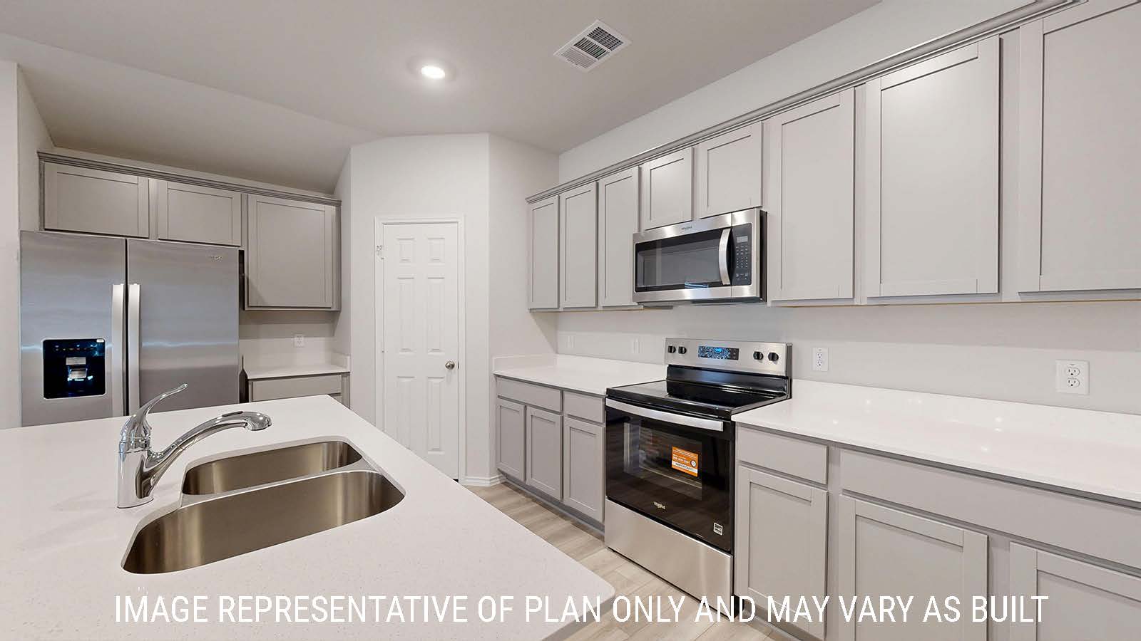 Gaven kitchen with kitchen island and light cabinets with white countertops.