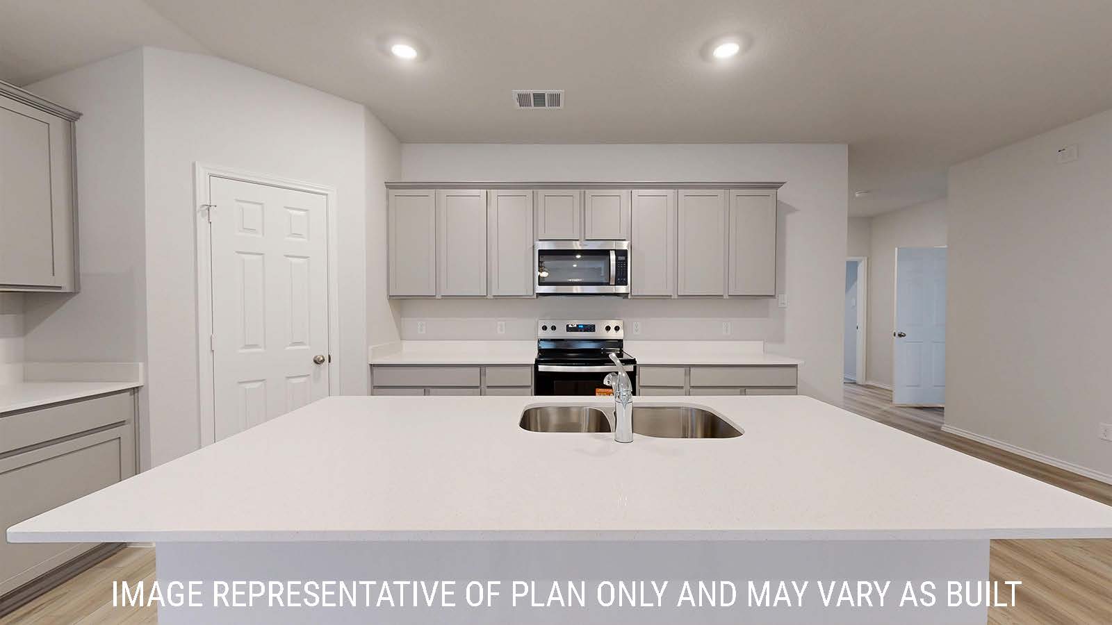 Gaven kitchen with kitchen island and light cabinets with white countertops.