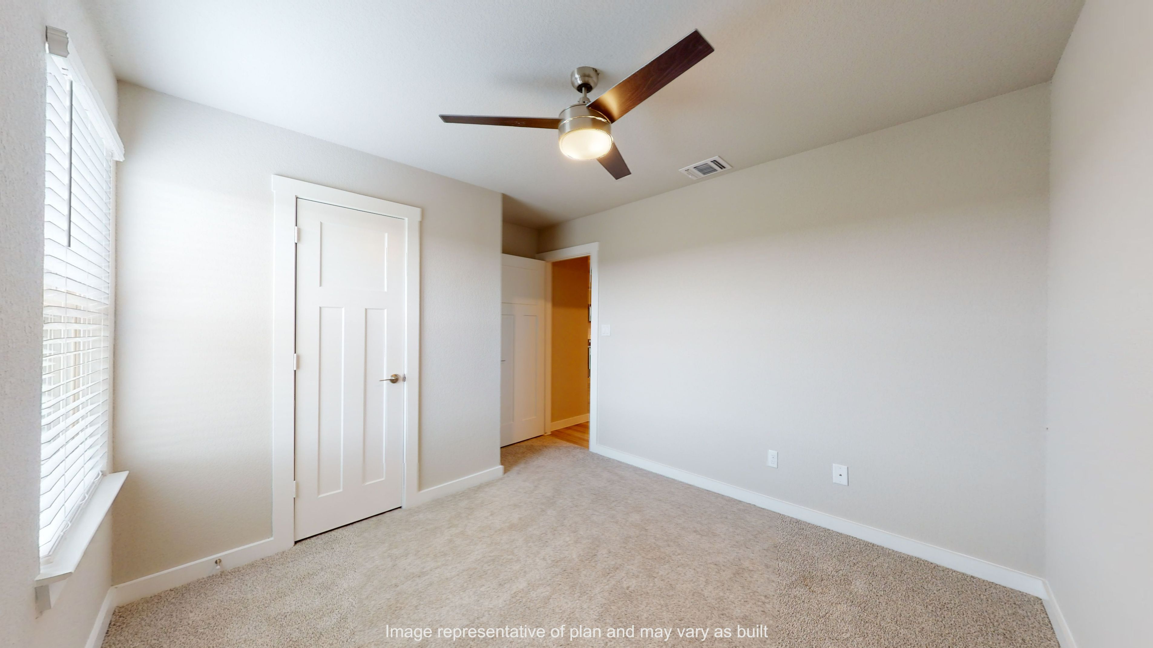 Gaven secondary bedroom with carpet flooring.