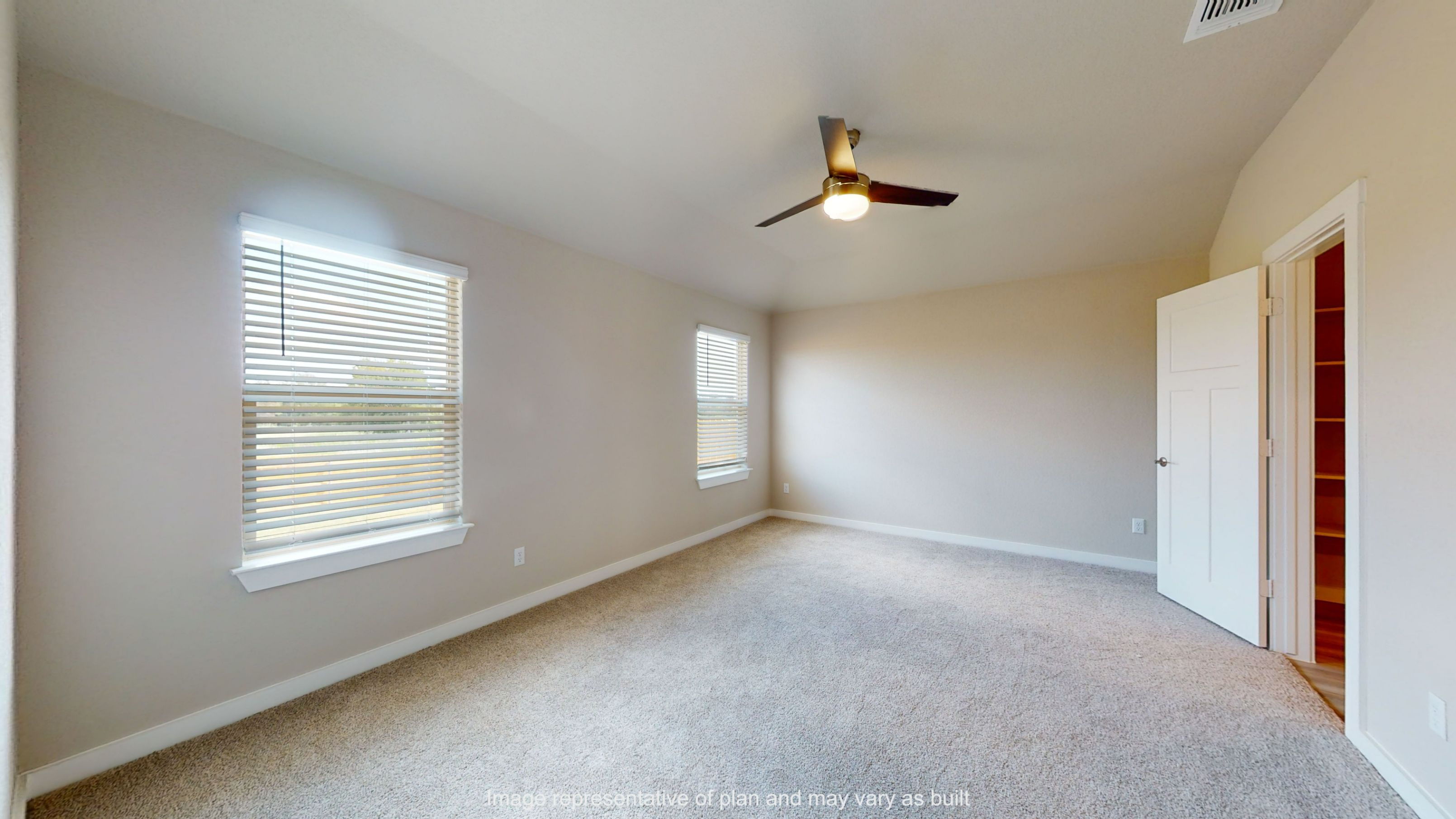 Gaven primary bedroom with carpet flooring and windows for natural light.
