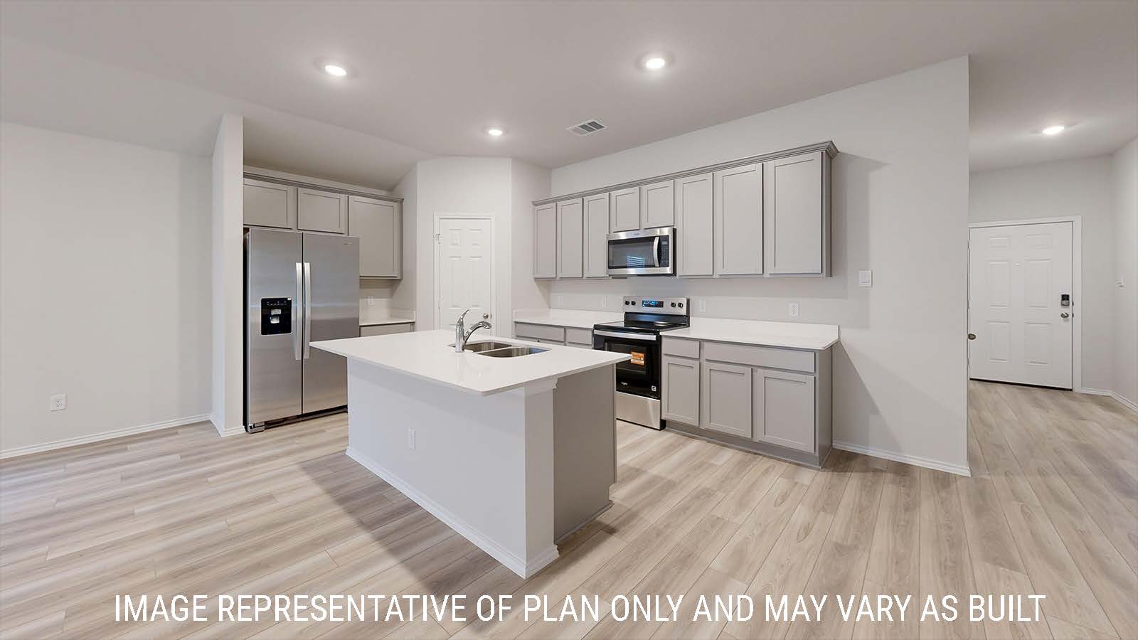 Gaven kitchen with light cabinets and white countertops with view of front hallway.