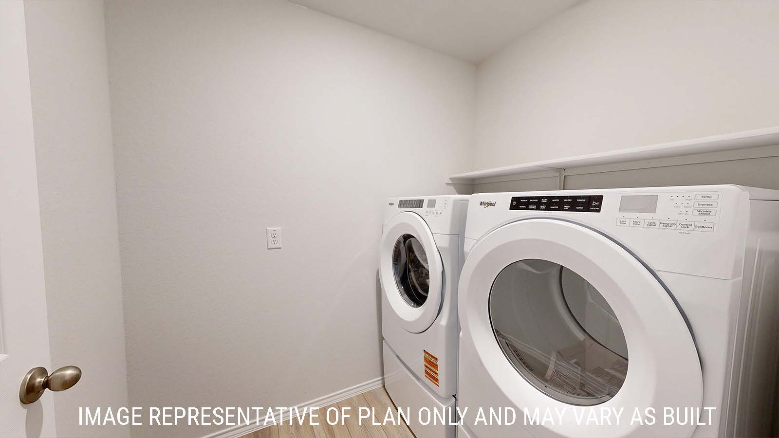 Gaven utility room with washer and dryer and shelving for storage.
